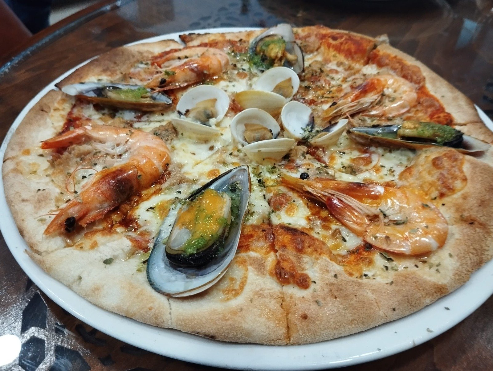 Seafood pizza topped with prawns, mussels and clams